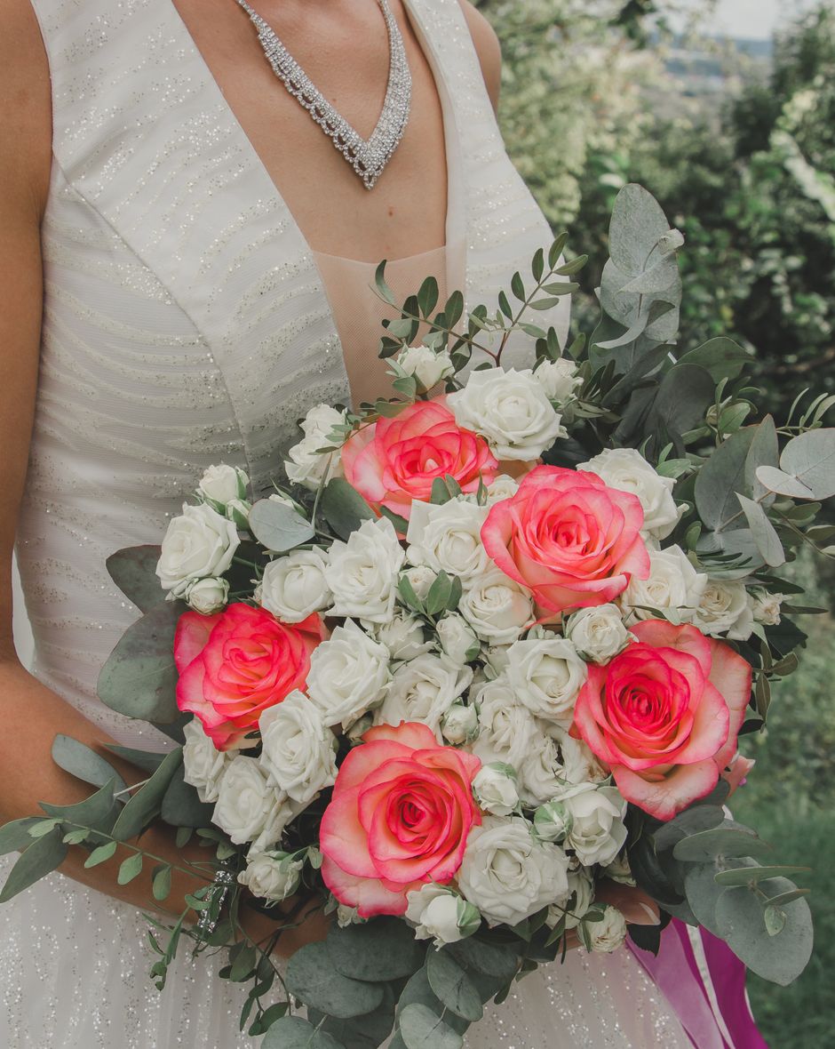 Bride holding a bouquet of pink and white roses