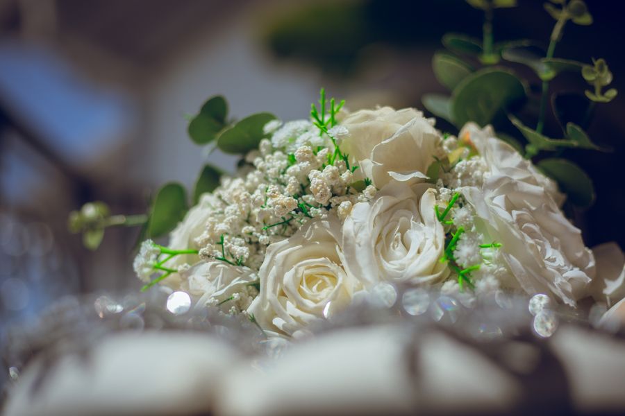 White boutonniere with greenery and ribbon